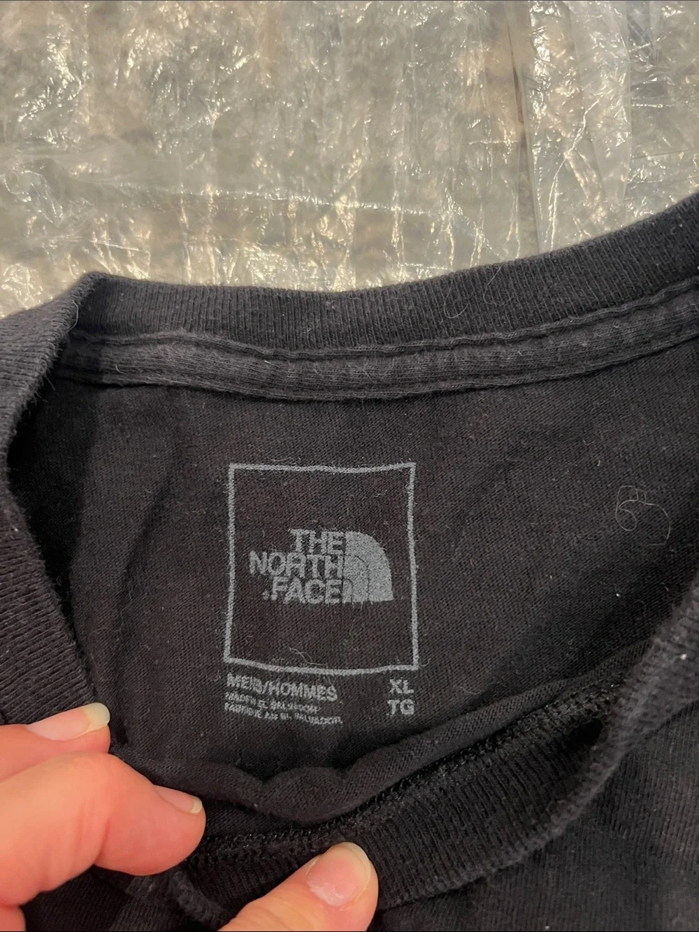 The North Face Black Tee with Gold Side Logo size XL.